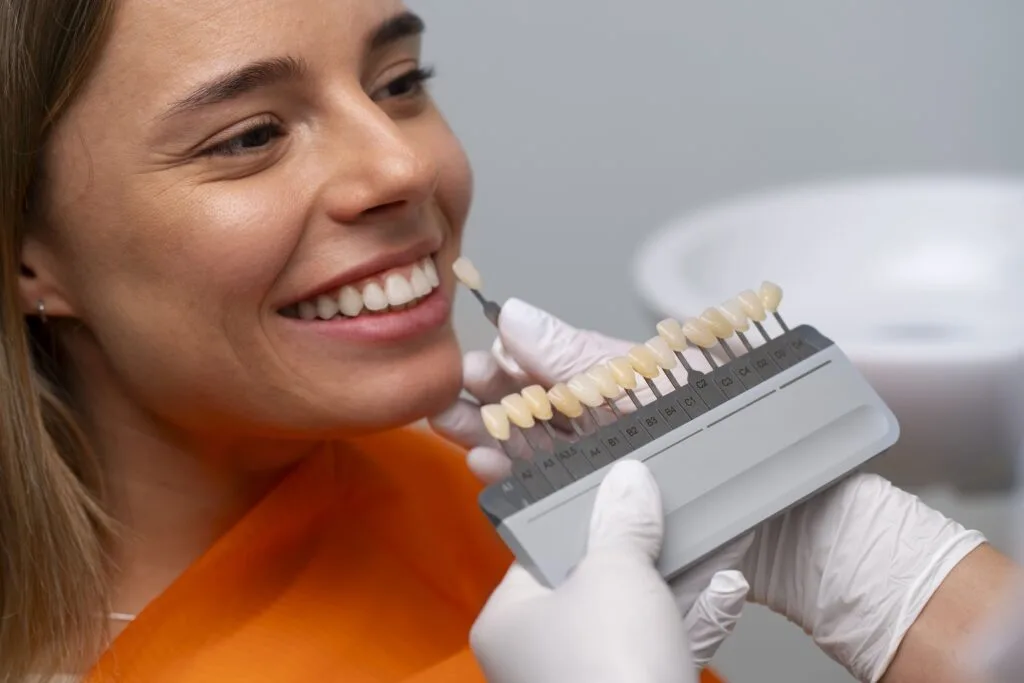 Dentist matching tooth shade for composite filling treatment at Apollo Dental Clinic Kolkata